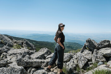 Traveler Woman standing above the city of Sofia in the  summer mountain .Vitosha Mountain ,Bulgaria 