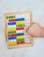 Kid hand playing with Wooden Educational Counting Toy With Beads