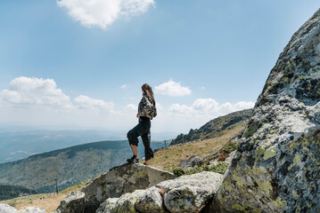 Traveler Woman standing above the city of Sofia in the  summer mountain .Vitosha Mountain ,Bulgaria 