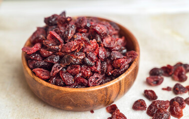 Dried cranberries in wooden bowl 