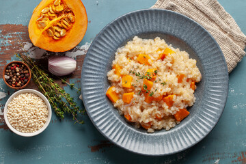 Pumpkin risotto with fresh thyme in plate. Italian Food. Top view