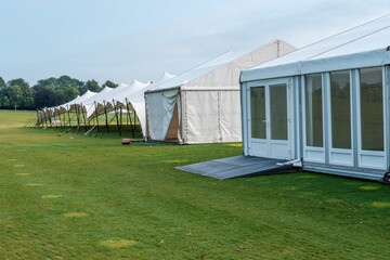 Obraz premium Marquee or gazebos in a field for cover at event.
