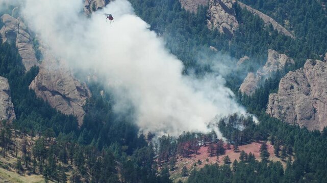 Firefighters in Helicopter Dumping Water in Dinosaur Fire, Boulder Colorado Firefighters on Wildfire Near Flatirons