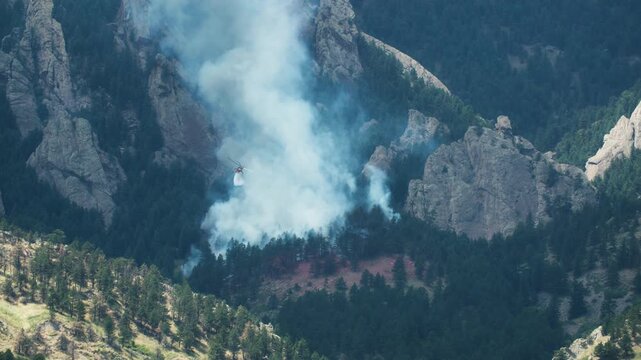 Firefighters in Helicopter Dumping Water on Dinosaur Fire in Boulder Colorado, Front Range Wildfire