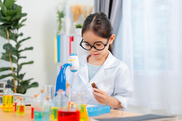 young Asia girl Scientist Conducting Experiment With Microscope In Laboratory