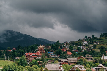 Fototapeta premium Traveling to the mountains in summer. Summer holiday in an authentic mountain village in summer.