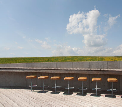 The Estonian Road Museum, open air museum grounds with exhibition and buildings. A roof terrace with a row of stools.