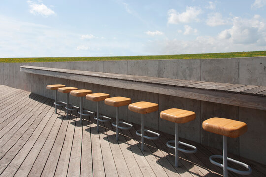 The Estonian Road Museum, open air museum grounds with exhibition and buildings. A roof terrace with a row of stools.