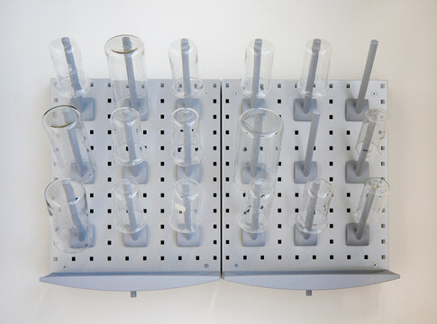 A wall rack of jars and flasks in the Chemistry laboratory at a university chemistry department .