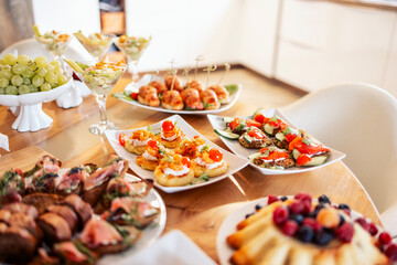 Close-up of delicious snacks on a wooden table in the dining room at home