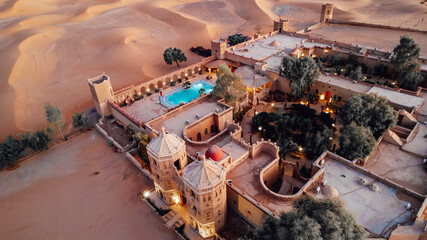 tourist couple they enjoying their Marriage proposal in the middle of the dunes in moroccan Sahara Desert
