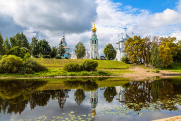View of the architectural ensemble of the Kremlin Square from the Vologda River and its reflection in the water. Vologda, Russia