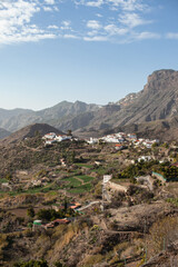 aerial panoramic view on the scenic mountains village Tejeda with white houses and red roofs on Gran Canaria island, Canary Islands, Spain. Travel tourism destination on sunny day. 