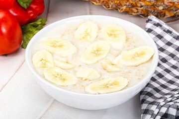 Sweet porridge with banana breakfast