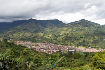 Obraz premium Cityscape of Jardin, Jardín, Antioquia, Colombia. Awesome landscape with the green Andes Mountains and a dramatic cloudy sky.