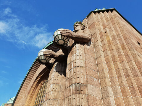 Helsinki Railway Station building, clad in granite,designed by Eliel Saarinen and inaugurated in 1919, the Lyhdynkantajat the lantern bearers, a group of sculptures at the front door