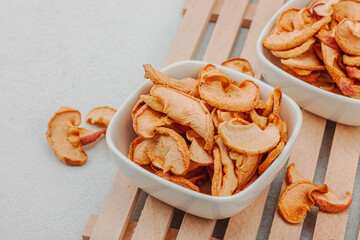 Dry pieces of apple in a bowls. Healthy food diet, vegan lifestyle, lose weight concept