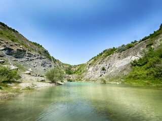 A wonderful landscape in the Carpathian mountains with a view of the lake between the rocks in sunny weather