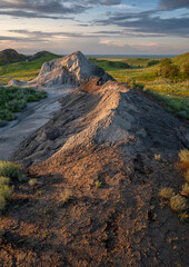 Setting sun over a mound of clay from a brick factory in Clay Valley at Claybank, Saskatchewan, Canada