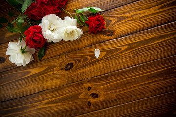 beautiful background of many red roses on a dark wooden background
