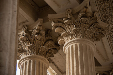 Ornate Classical Columns of Antique Design with detailed Corinthian Capitals Decorated with intricate Leaf pattern. Architectural elements Historic building characterized exquisite craftsmanship