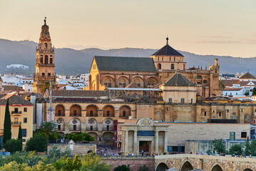 Fototapeta premium Panoramic view of the Mosque-Cathedral across the Calahorra Tower and the Roman Bridge over the Guadalquivir River, Cordoba, Andalusia, Spain.