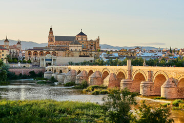 Naklejka premium Panoramic view of the Mosque-Cathedral across the Calahorra Tower and the Roman Bridge over the Guadalquivir River, Cordoba, Andalusia, Spain.