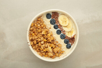 Granola with fresh summer berries in a bowl on light background. Concept of healthy breakfast food