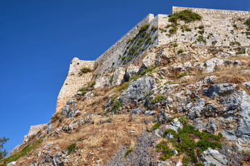 Stone fortifications of the Venetian fortress on a rocky hill in the city of Rethymno on the island of Crete in Greece