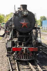 Black steam locomotive with red star from USSR times close up