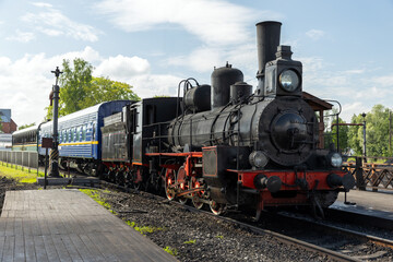 Vintage passenger train with black steam locomotive