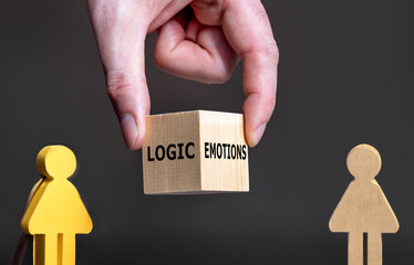Hand holds a cube with the words 'logic' and 'emotions' between a male and a female figure.