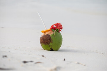 Tropical cocktail in a coconut on a beautiful beach, paradise, exotic holiday, white sand, ocean