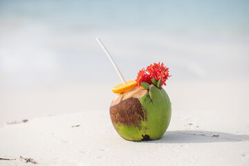 Tropical cocktail in a coconut on a beautiful beach, paradise, exotic holiday, white sand, ocean