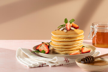 Delicious Fluffy Pancakes with Fresh Strawberries and Almonds and a Touch of Sweetness