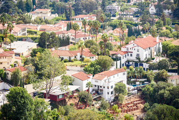 View from above of detached houses and villas in a hillside residential district of Los Angeles on a sunny autumn day