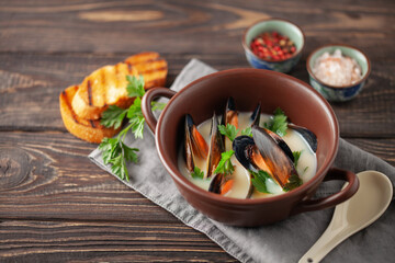 Cream soup with mussels in shell . Sea food background.