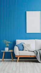 A white sofa with a throw blanket and a pillow is positioned in a modern living room with a blue wall. A small wooden side table sits nearby