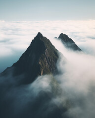 Fototapeta premium ultra realistic shot of mountain peak ridge peaking out of cloud field