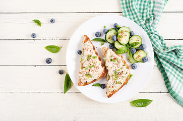 Toasts with tuna. Italian bruschetta sandwiches with pate canned tuna, egg and cucumber. Top view,...