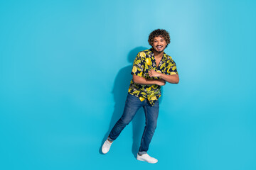 Photo of attractive handsome man wear blue clothes pullover empty space isolated on yellow color background