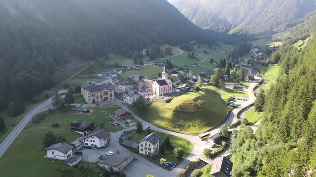 Aerial footage of Trient village in Switzerland, showcasing the charming historic church and the surrounding picturesque landscape nestled in the Swiss Alps. Trient, Switzerland, Schweiz.