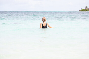 Girl swims in the ocean, summer vacation, vitamin D, vacation with children