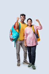 Obraz premium Two Happy Indian College Students with Bags and Laptop, Isolated on White Background