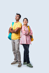 Fototapeta premium Two Happy Indian College Students with Bags and Laptop, Isolated on White Background