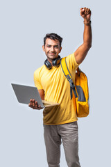 Indian asian happy young college boy with backpack, laptop and books