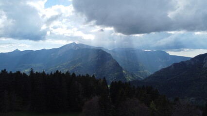 Majestic Mountain Landscape with Sun Rays Breaking Through Clouds