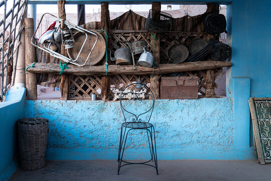 Moroccan blue patio decorated with traditional old utensils and objects