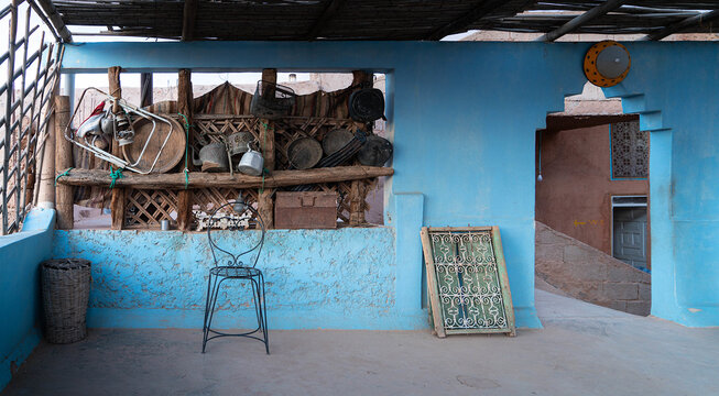 Moroccan blue patio decorated with traditional old utensils and objects