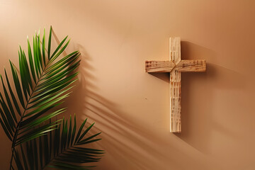 Wooden cross hanging on a beige wall beside a palm leaf, casting shadows in soft sunlight. Simple, serene, and spiritual decor.
